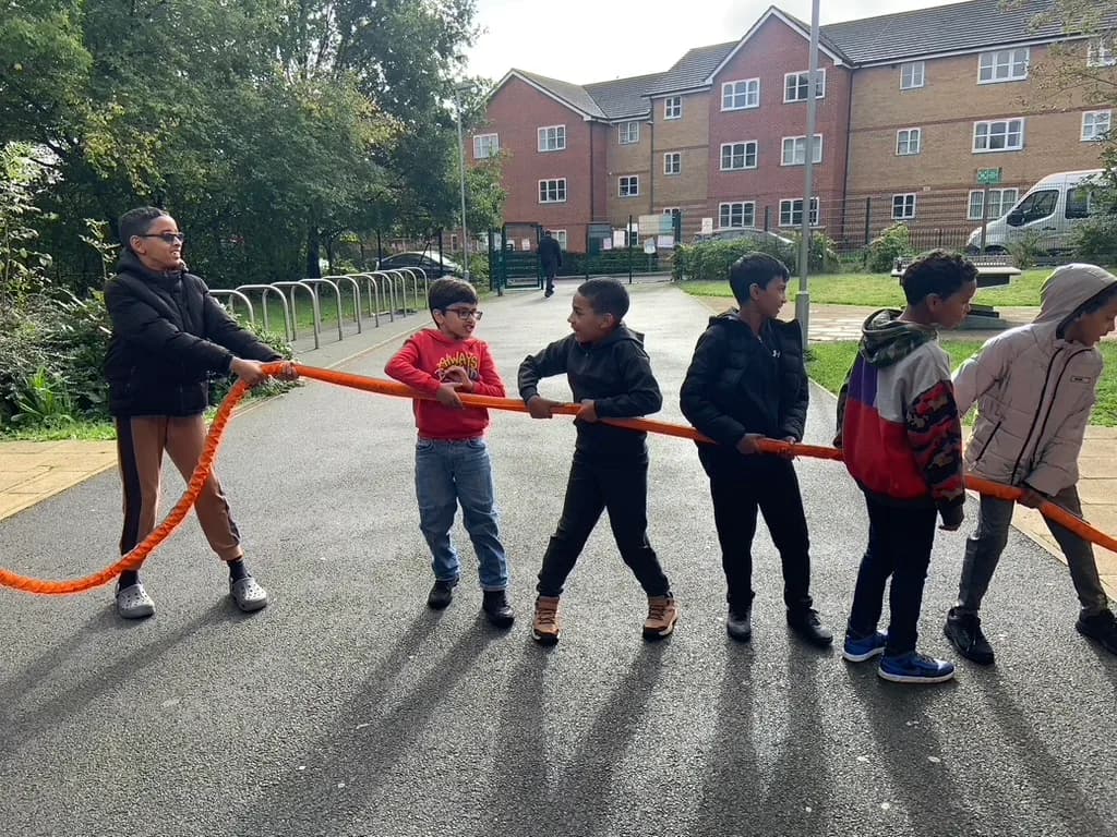 Students taking part in a tug of war outdoors