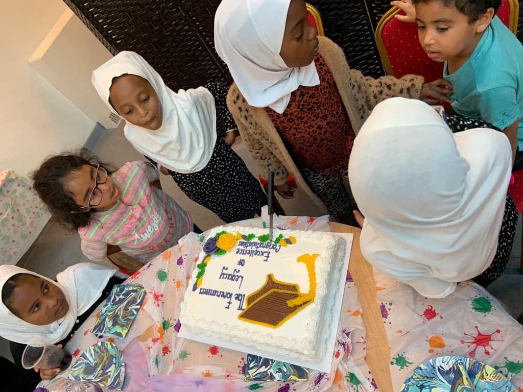 Pupils gathered around a celebration cake
