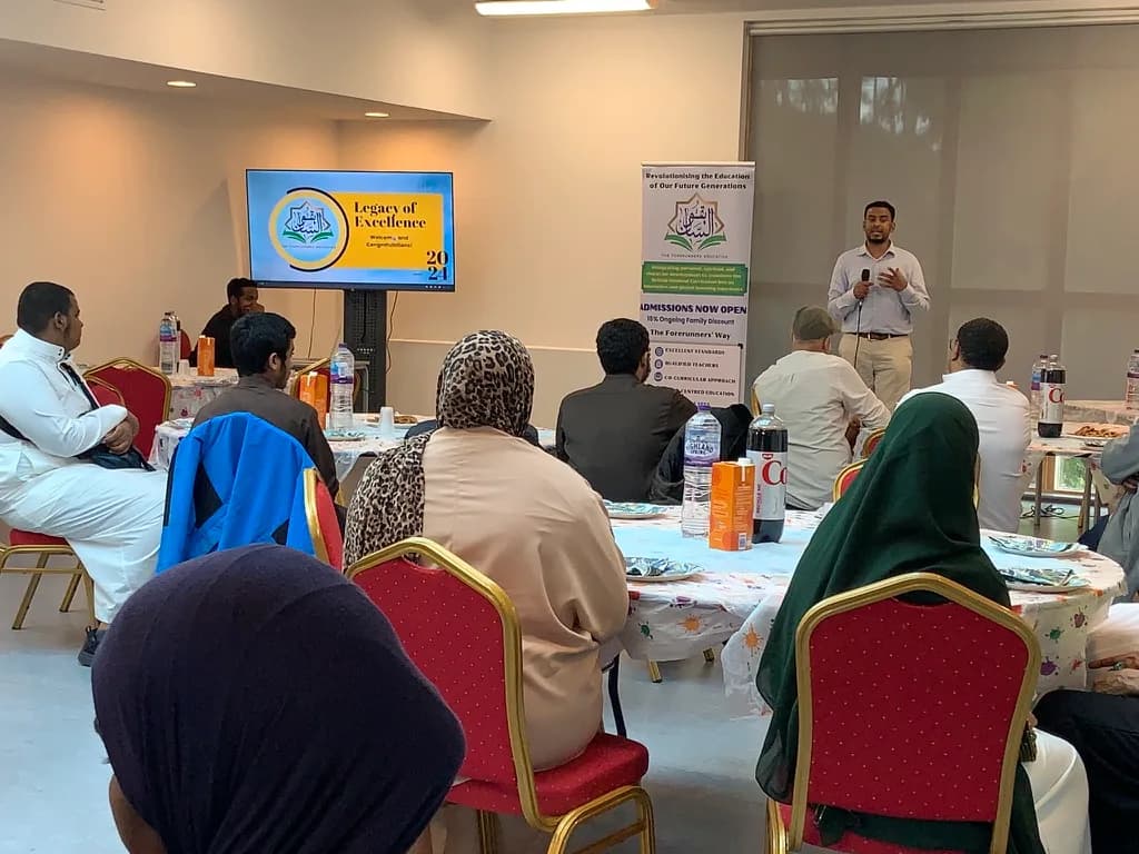 A speaker addressing families at a school event