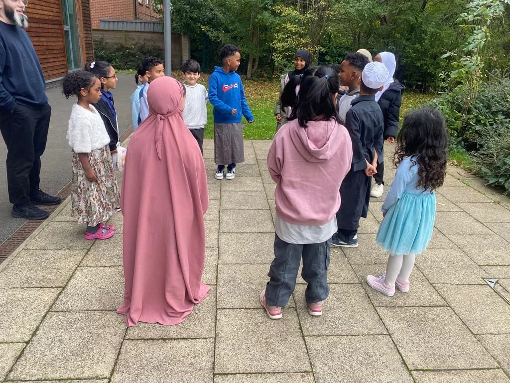 Children walking together outdoors at an in-person meet-up