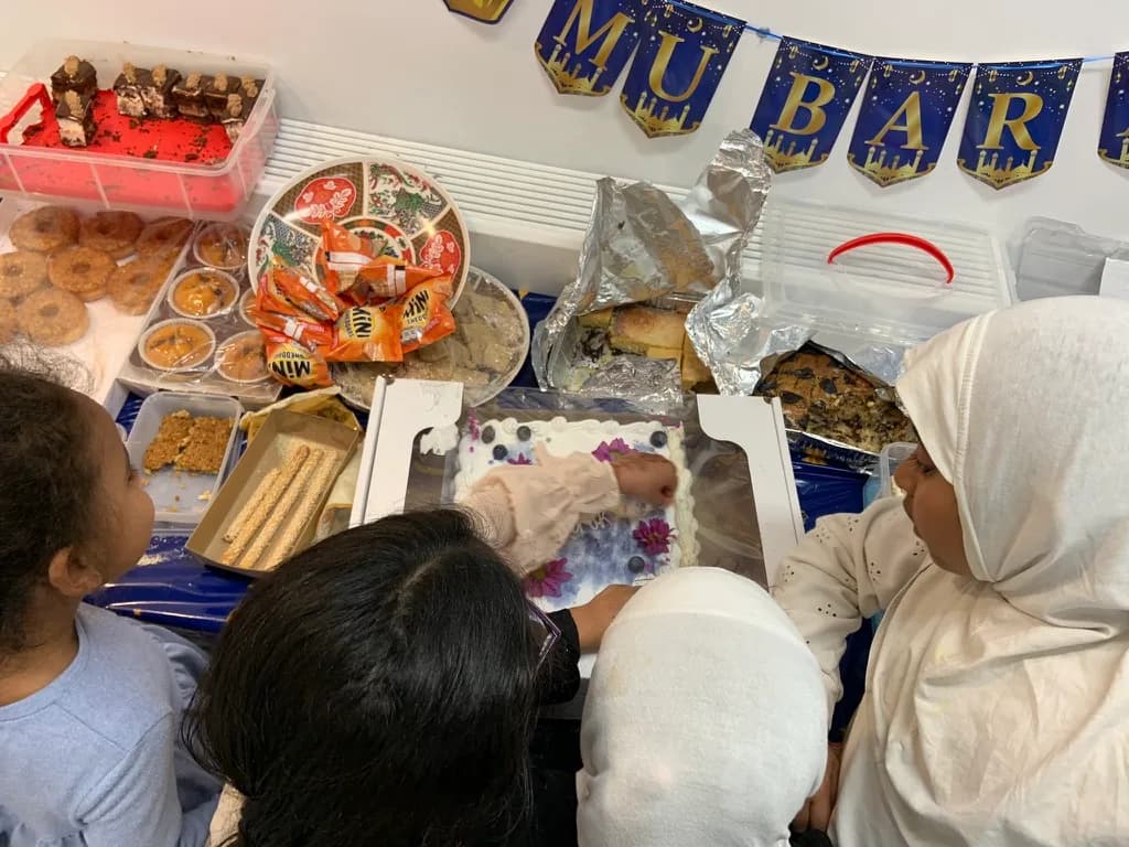 A table of food laid out for an Eid gathering