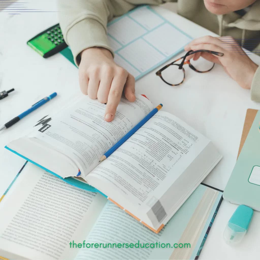 A student working through a textbook at a desk
